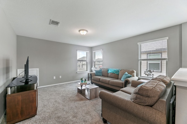 living area with carpet flooring, visible vents, and baseboards