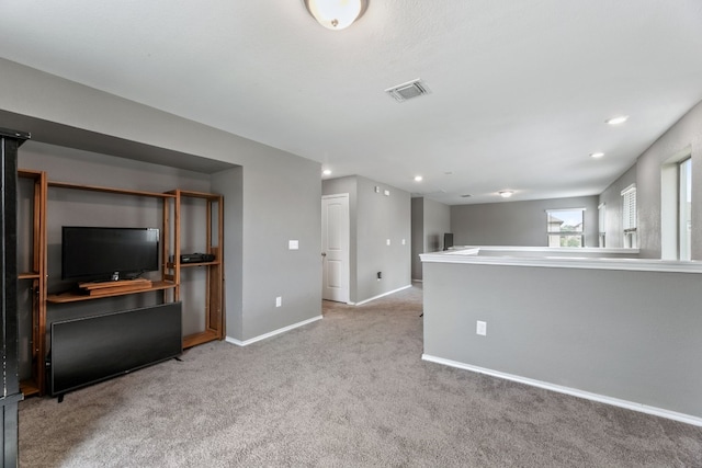 unfurnished living room featuring carpet floors, recessed lighting, visible vents, and baseboards