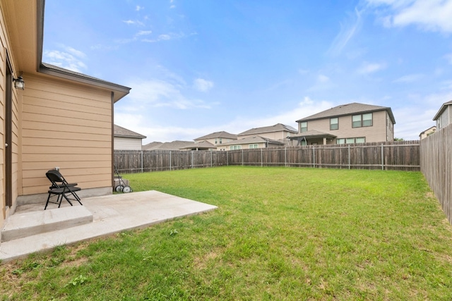 view of yard with a residential view, a patio area, and a fenced backyard