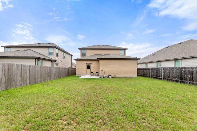 back of house featuring a patio area, a yard, and a fenced backyard