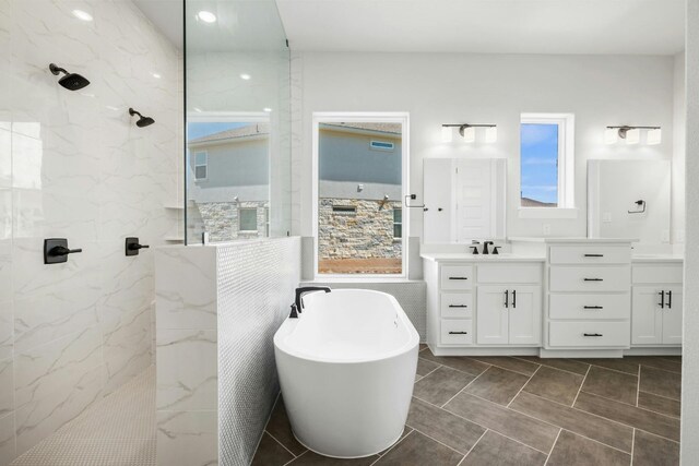 bathroom with shower with separate bathtub, vanity, and tile patterned floors