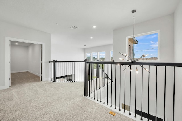 hallway with recessed lighting, an upstairs landing, baseboards, visible vents, and carpet