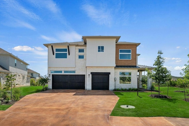 contemporary house with concrete driveway, metal roof, an attached garage, a standing seam roof, and a front yard