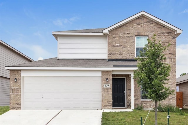 view of front of property with a garage and a front lawn