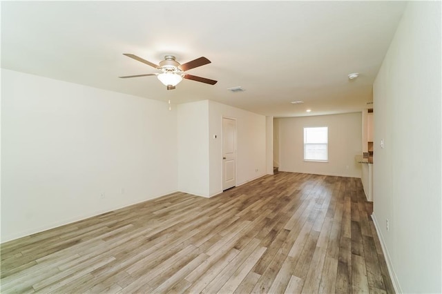 spare room featuring ceiling fan and light hardwood / wood-style floors