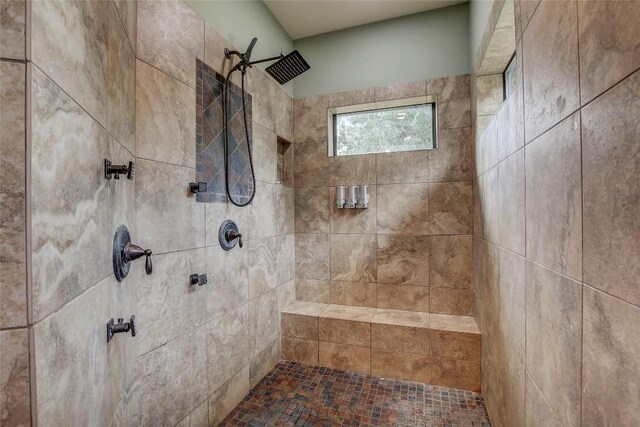 bathroom with tiled shower