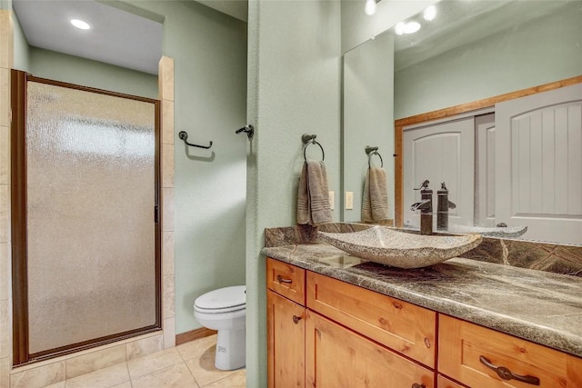 bathroom with vanity, an enclosed shower, tile patterned flooring, and toilet