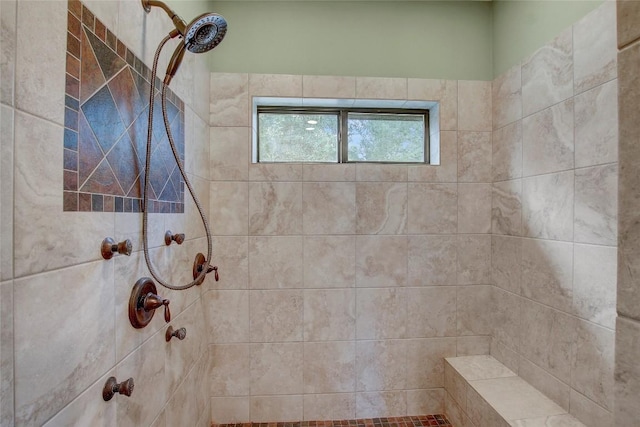 bathroom with a tile shower