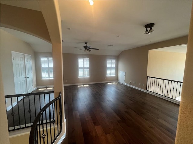 unfurnished room with ceiling fan, dark hardwood / wood-style flooring, and vaulted ceiling