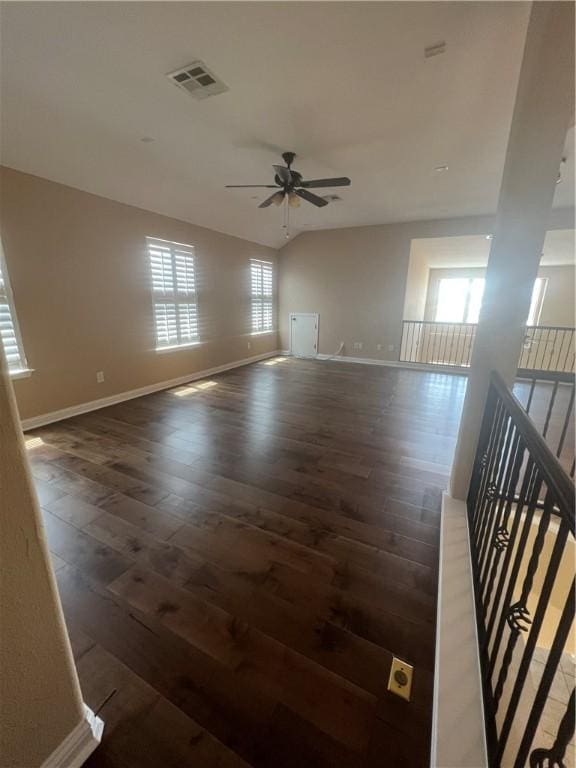 empty room featuring vaulted ceiling, ceiling fan, and dark hardwood / wood-style floors