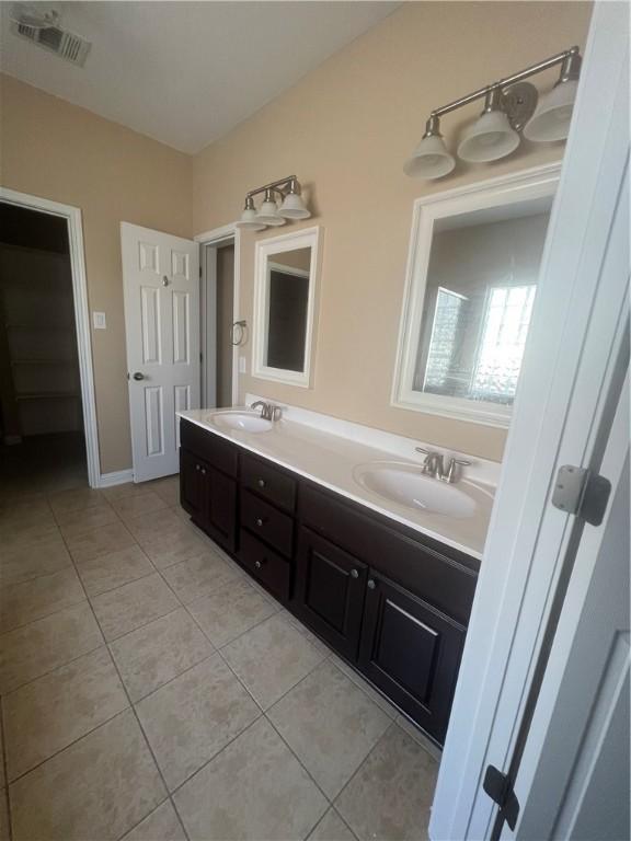 bathroom with tile patterned flooring and vanity