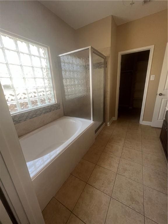 bathroom featuring tile patterned floors, vanity, and plus walk in shower