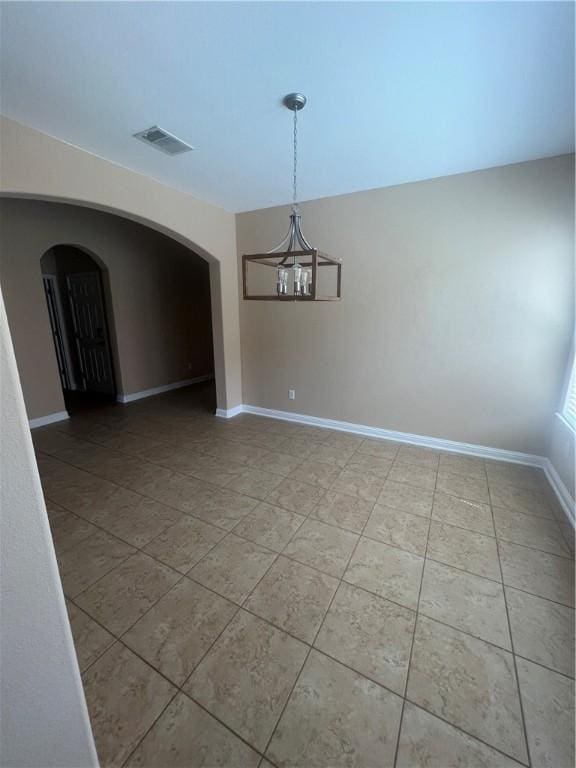 unfurnished dining area with tile patterned floors and a notable chandelier