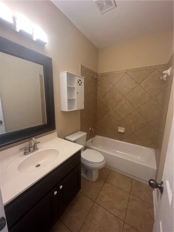 full bathroom with tile patterned floors, toilet, vanity, and tiled shower / bath