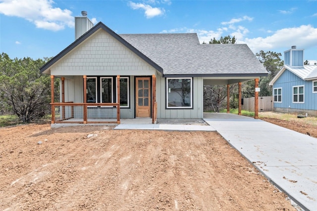 view of front of house with a porch and a carport