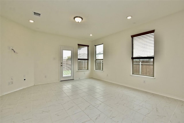 spare room featuring a wealth of natural light