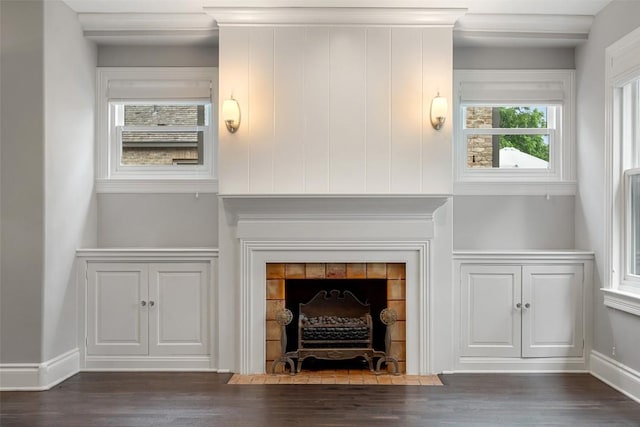 room details with hardwood / wood-style flooring and a tiled fireplace