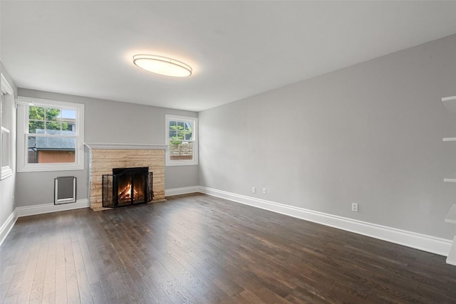 unfurnished living room featuring dark hardwood / wood-style floors and a fireplace