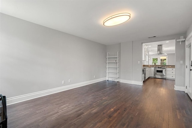 unfurnished living room with dark hardwood / wood-style flooring