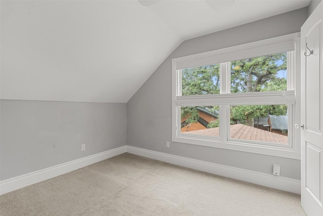 bonus room featuring carpet and vaulted ceiling