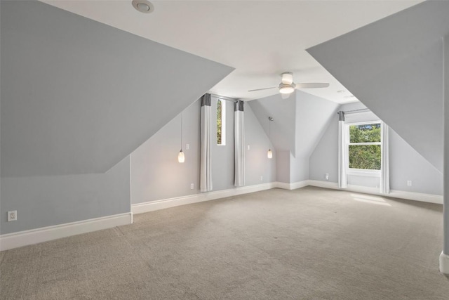 additional living space featuring carpet floors, ceiling fan, and lofted ceiling