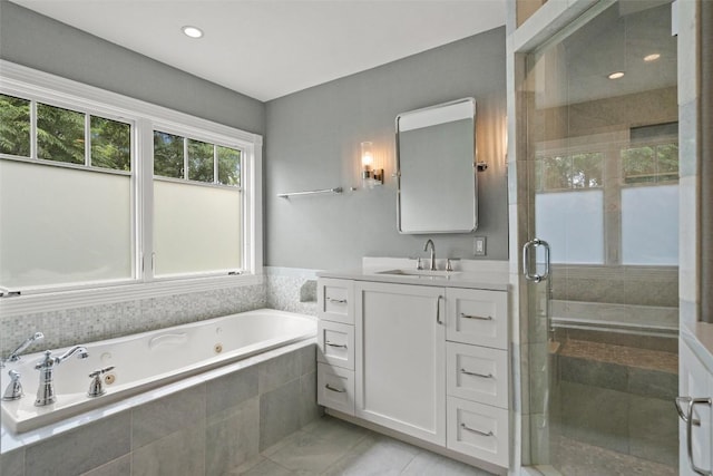 bathroom with vanity and independent shower and bath