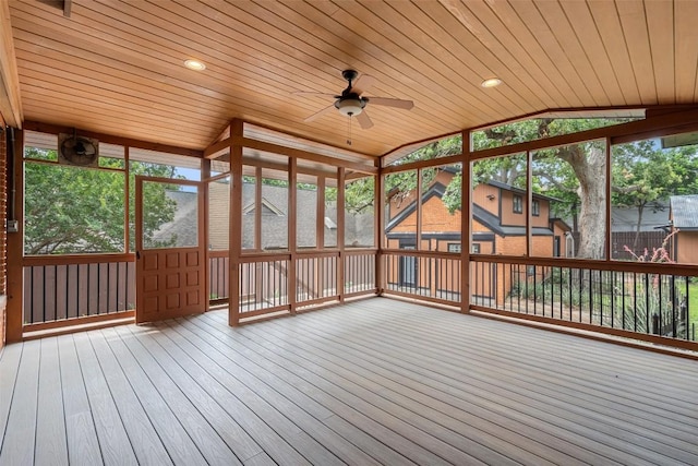 unfurnished sunroom featuring ceiling fan, wood ceiling, and lofted ceiling