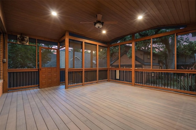 unfurnished sunroom with lofted ceiling, ceiling fan, and wooden ceiling