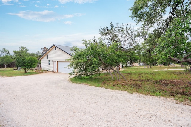 view of property hidden behind natural elements with a garage