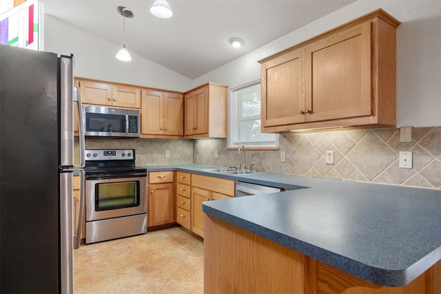 kitchen with sink, stainless steel appliances, kitchen peninsula, pendant lighting, and lofted ceiling