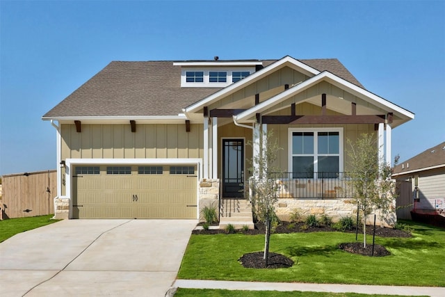 craftsman-style home featuring a garage and a front yard