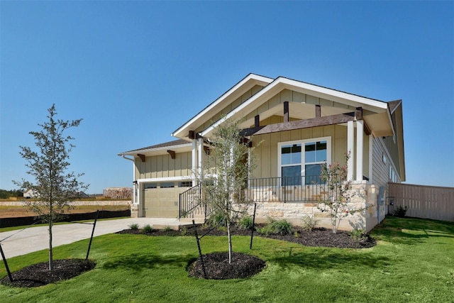 view of front facade featuring a front lawn, a porch, and a garage