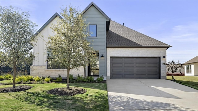 view of front of house featuring a garage and a front lawn