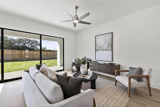 living room with ceiling fan and light wood-type flooring