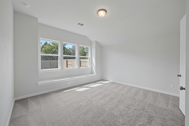 additional living space with carpet flooring and vaulted ceiling