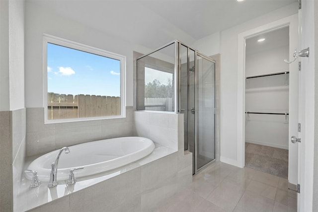 bathroom with tile patterned flooring and separate shower and tub