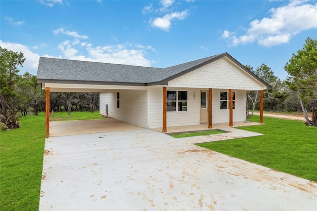 ranch-style home featuring a carport, covered porch, and a front yard