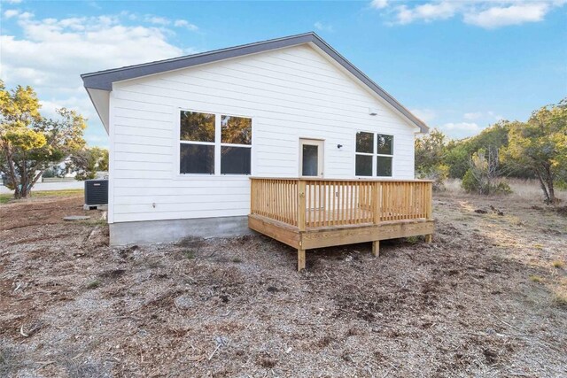 rear view of property with central AC unit and a deck