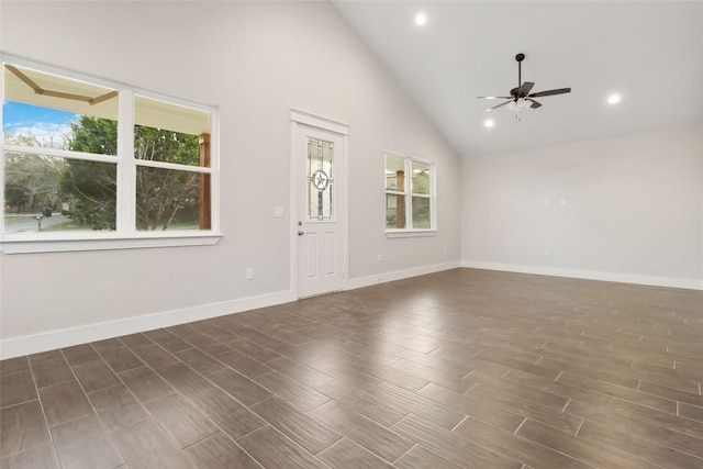 unfurnished room with high vaulted ceiling, dark wood-type flooring, and ceiling fan