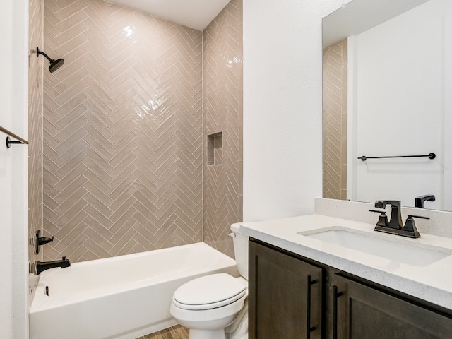 full bathroom featuring vanity, toilet, and tiled shower / bath combo