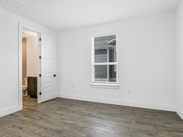 empty room featuring dark hardwood / wood-style flooring