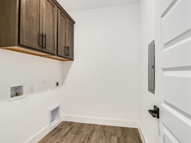 laundry room with cabinets, electric panel, hookup for a washing machine, dark hardwood / wood-style floors, and hookup for an electric dryer