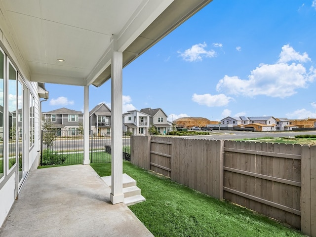 view of patio / terrace featuring a fenced backyard and a residential view