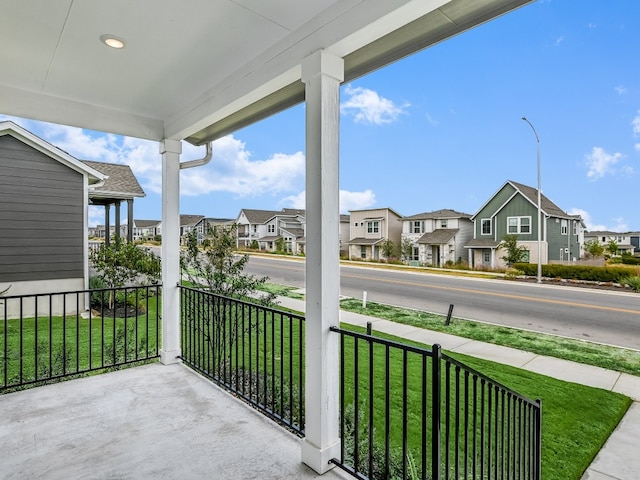 balcony with covered porch and a residential view