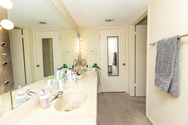 bathroom with vanity and a textured ceiling