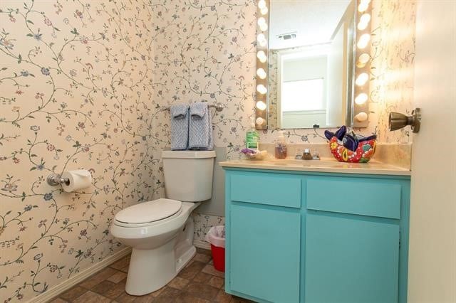 bathroom with tile flooring, vanity, and toilet