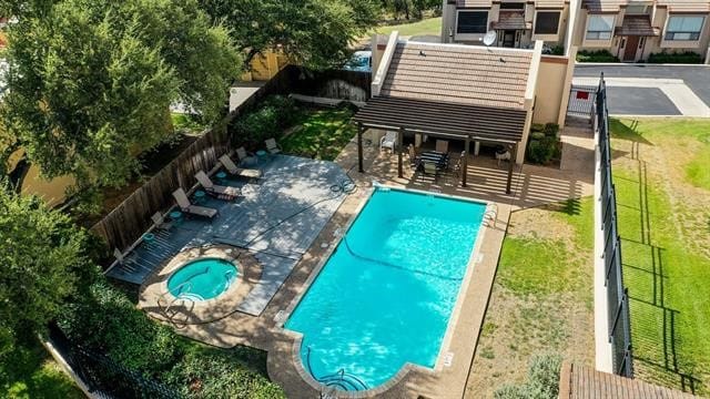 view of pool with a patio area and a yard