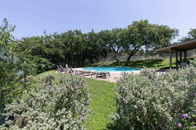 view of swimming pool with a lawn