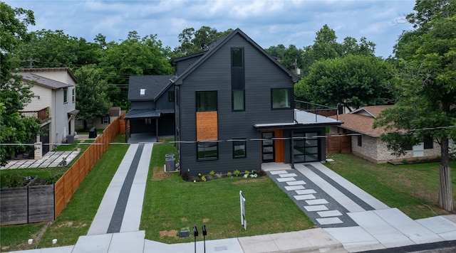 view of front of house with cooling unit and a front yard