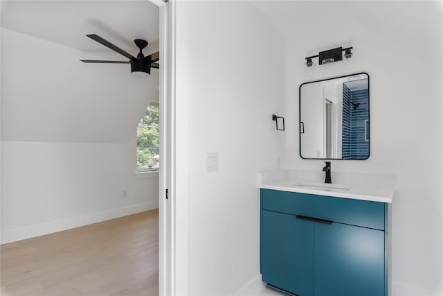 bathroom featuring vanity, vaulted ceiling, ceiling fan, and hardwood / wood-style floors